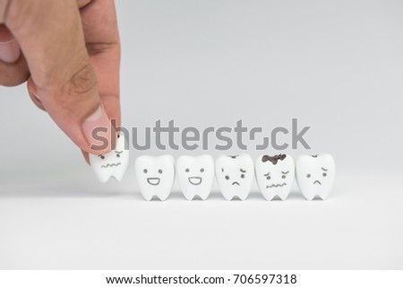 Dentist hand set of decayed tooth model for dental health care concept