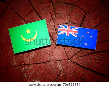 Mauritania flag with New Zealand flag on a tree stump isolated