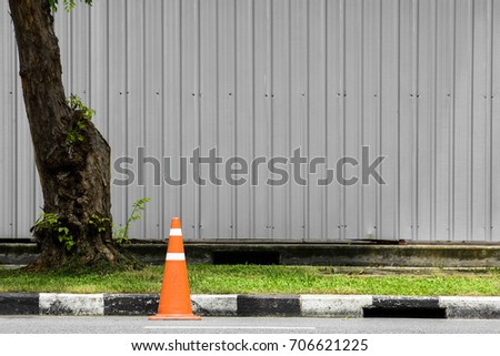 orange traffic cone on asphalt road