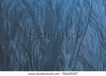 Dark sand as the background image with wave shaped structure.