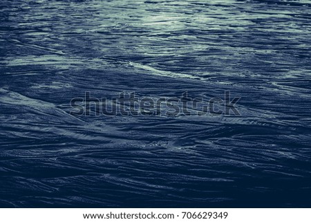 Dark sand as the background image with wave shaped structure.