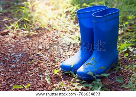 Rubber boots covered with mud in front