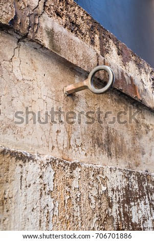 Ancient Roman ring in the wall for horses. Via della Reginella. Rome, Italy