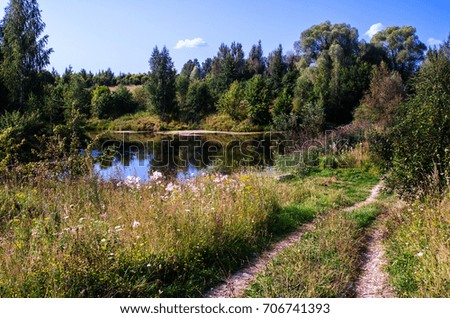 Landscape is the beginning of autumn. Pond in the ravine. The colors of late summer.