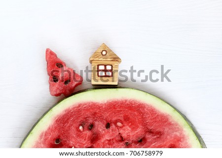Red sweet Christmas tree and a lodge on a hill of watermelon slices / slides Christmas landscape