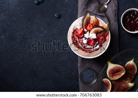 Almond milk bowl with strawberries and figs. Dark food photography concept. Flatlay with copy space