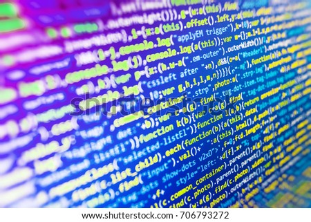 WWW software development. IT specialist workplace. CSS, JavaScript and HTML usage. Programming of Internet website. Javascript functions, variables, objects. Website codes on computer monitor. 
