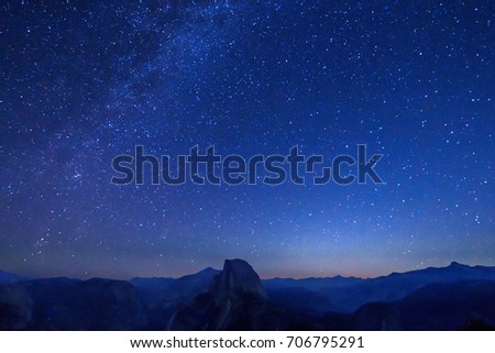 Milky way, stars and galaxy in the night sky with Half Dome, Yosemite national park, taken from glacier point