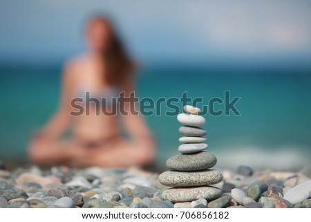 Woman practicing yoga meditation on nature beach shores 
