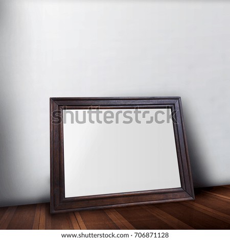 Blank wooden Photo frame on wood floor leaning the wall use for product display.