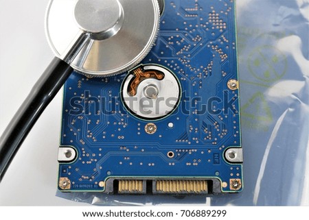 An concept image of a hard drive, disk and a stethoscope