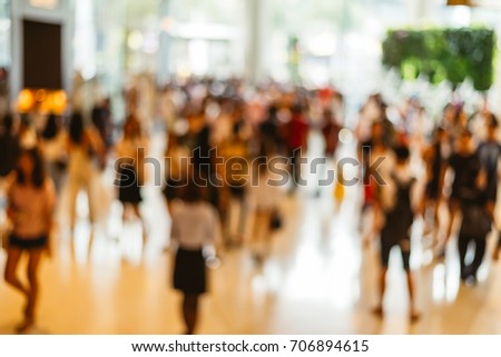 Blur image of a crowd of people walking at shopping mall,vintage tone