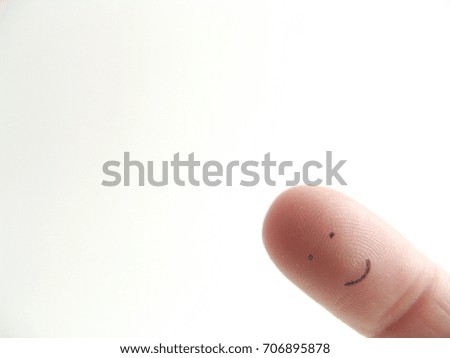 Smiling face on a finger 