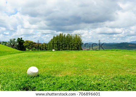 tee off with forest and blue sky and cloud background.