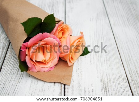 Pink roses on a old white wooden background
