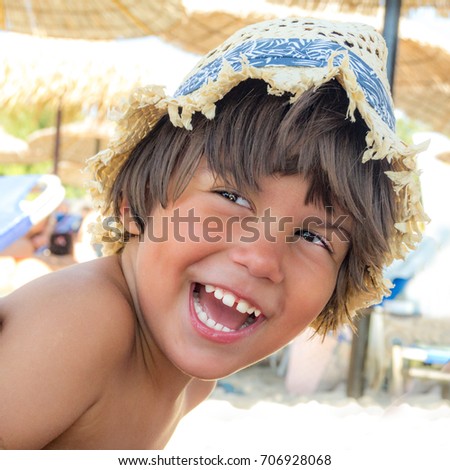 Portrait of a boy with hat on the  beach