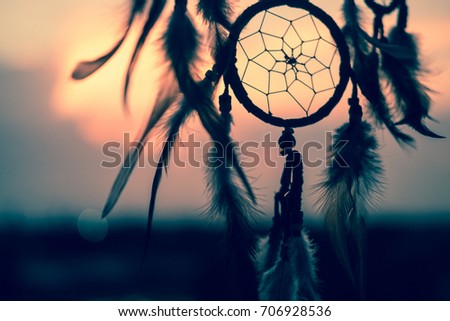 Dream Catcher on the sunset background Royalty-Free Stock Photo #706928536
