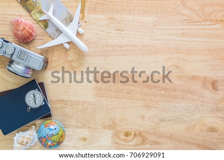   Outfit and accessories of traveler on blue background with copy space, Travel concept.Overhead view of Traveler's accessories, Essential vacation items, Travel concept on wooden background. top view