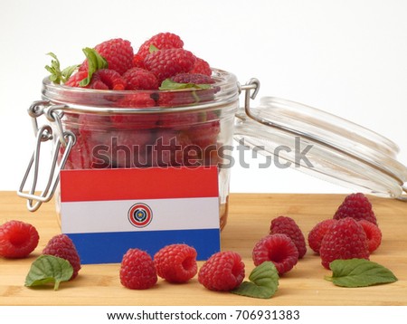 Paraguay flag on a wooden panel with raspberries isolated on a white background