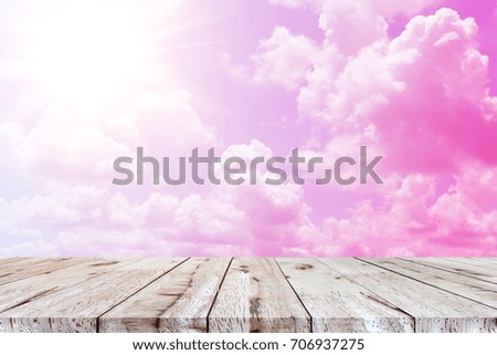Empty perspective brown wood plank table top with abstract colorful blue sky with cloud background, for montage of your product