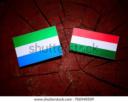 Sierra Leone flag with Hungarian flag on a tree stump isolated