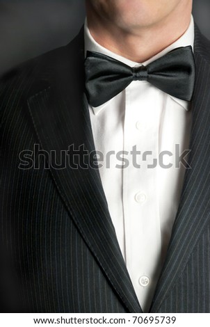 A close-up shot of a man wearing a tux. Royalty-Free Stock Photo #70695739
