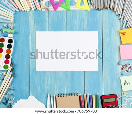 School supplies frame on a blue wooden background