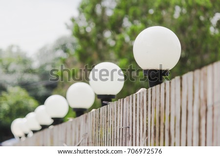 Milestone White sphere lights mounted on the roadside fence.
White light on the road on old brown wood fence.
Ideas with step by step distance and time.