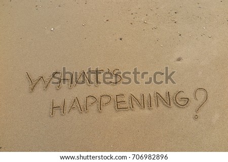 Handwriting  words "WHAT'S HAPPENING?" on sand of beach. Royalty-Free Stock Photo #706982896
