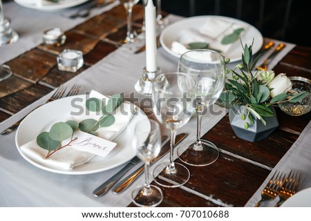 place cards with the guest's name on the plate. A beautiful table for any occasion, holiday, party or wedding. Royalty-Free Stock Photo #707010688