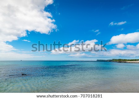 Beautiful Blue Ocean, Galapagos. Waves on the Beach with Blue Sky Background. Tropical Nature Landscape. Tropical Paradise Isolated Island. Clean Blue Ocean View. Nobody Sea Tropical Pattern. Summer