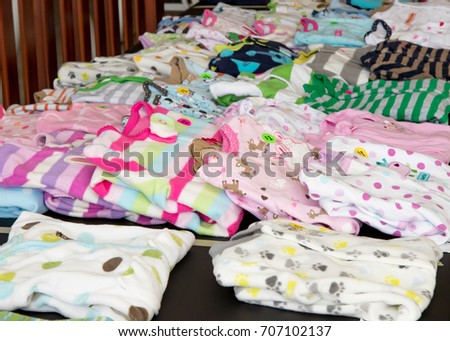 Children's pajamas on display at suburban garage sale Royalty-Free Stock Photo #707102137
