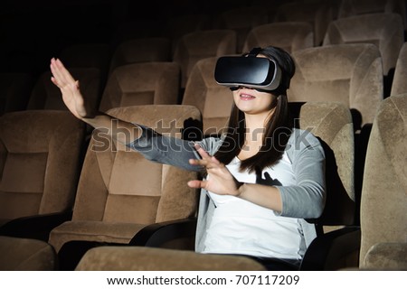 Handsome young woman wearing virtual headset. Smiling hipster using VR glasses.