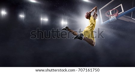 Basketball player on big professional arena during the game. He is wearing unbranded clothes. Royalty-Free Stock Photo #707161750