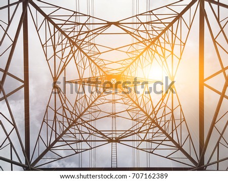 High voltage towers and sun and under the high voltage towers.