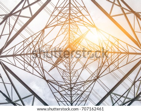 High voltage towers and sun and under the high voltage towers.