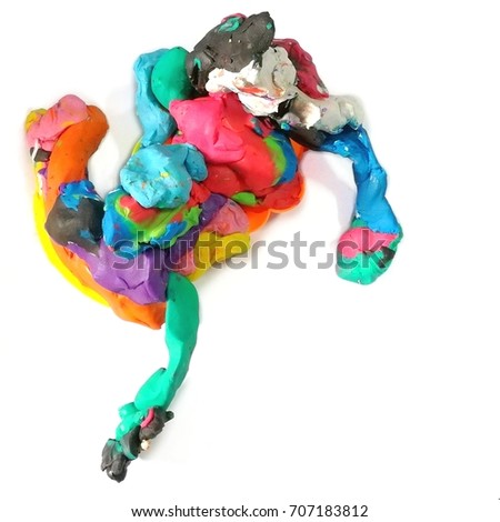 A variety of colored plasticine (clay)mixed together in a strange shape on a white background