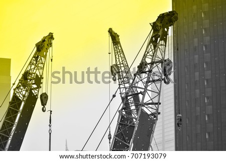 three cranes on contruction