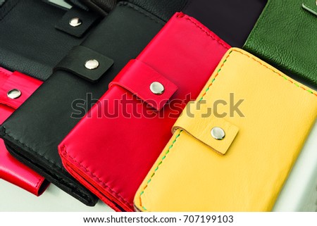 photo background leather wallets of different colors lie on the counter close-up