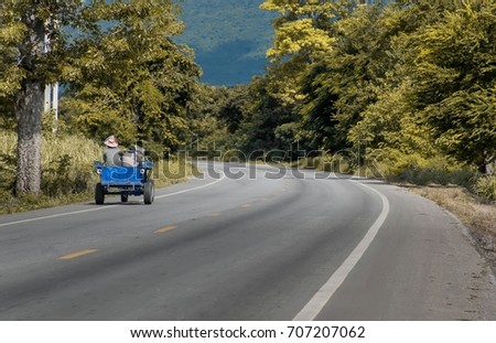 Farmer's journey with long road in the village,long road in countryside with blue sky.
