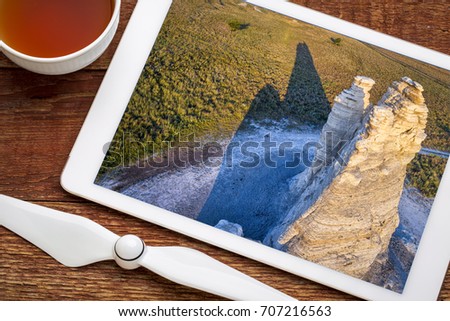 Castle Rock  - limestone pillar landmark in prairie of western Kansas near Quinter, revieing aerial image on a digital tablet