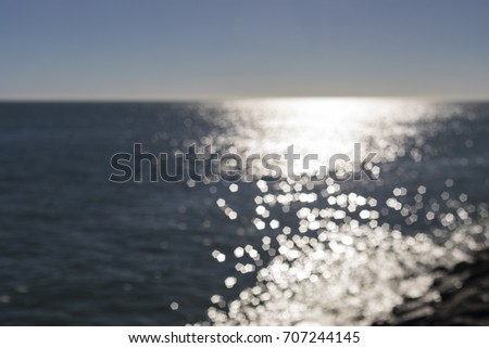 Horizon view over Atlantic Ocean from Jard sur Mer in Vendee, France with reflection of sun light over the water
