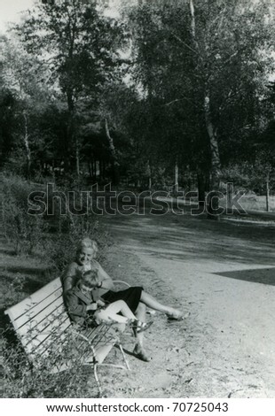 Vintage photo of mother and daughter on bench (fifties)