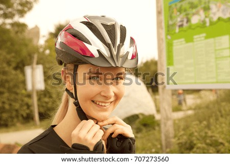 portrait of a blond woman with skating protection helmet