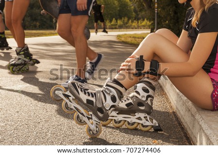 woman holds her shin while having a break sitting on curb