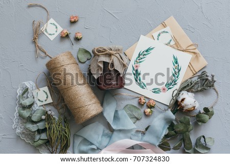 A wedding concept. Invitation and items on a grey stone background.