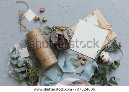 A wedding concept. Invitation and items on a grey stone background.