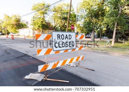 Residential street blocked by Road Closed construction sign.