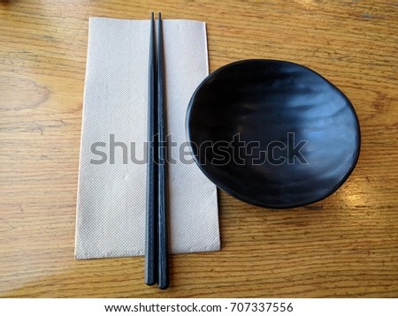 Japanses rasturant table set, paper, plastice chopstick and soy sauce bowl.