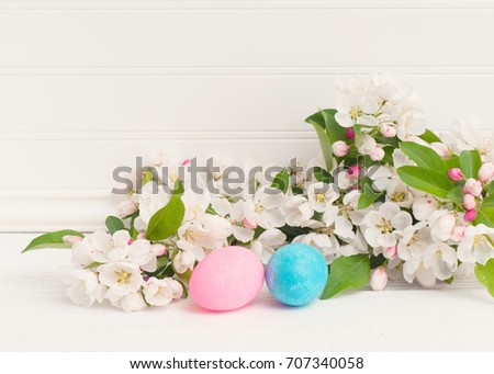 Easter Egg Still Life Scene with White Apple Blossoms on Rustic and Distressed White Board Table and Background Wall with Room or Space for copy, text, or your words.  Horizontal side angle view